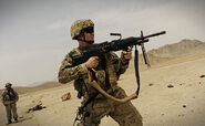 800px-Airman firing Mk 48 near FOB Mehtar Lam