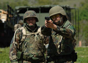 US Navy 060419-N-7590D-037 U.S. Navy Journalist 2nd Class Brooke Armato practices her aim, while U.S. Air Force Master Sgt