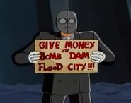 Поскольку из-за железных масок никто не мог понять их речь, Люди Идей доносили до людей свои требования в текстовом виде. На табличке написано: "Отдавайте деньги или взорвем дамбу и затопим город".