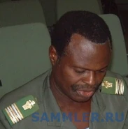 Подполковник инженерных войск Бенина. Дизайн эмблемы, схож с принятым во французской армии — античный шлем и кираса.