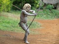 11786137-papua-new-guinea--september-16-mudman-warrior-aims-with-his-bow-at-goroka-tribal-festival-papua-new-