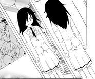 Tomoko looking at herself in the mirror.