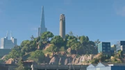 A view of Coit Tower from Pier 39, with Transamerica Pyramid in the background.