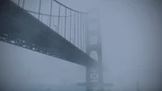 The bridge while covered in thick fog.