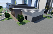 A back angle of the buildings's interior featuring the small garage door.