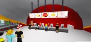A picture of Pizza Planet, with the cashiers seen in it.