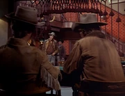 Shane and his companion are having a drink when someone comes walking up to them.