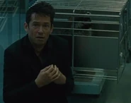 A racoon in a cage behind Lee Sizemore in the Mesa