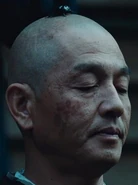 A beetle on top of a Buddhist monk's head in Hirafuku