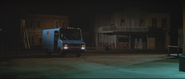 Van departing the town's main street, headed for labs