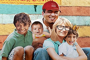 The family photo of Dawn, Sanjay, Milton, Lewis, and Edith from Dawn's classroom desk.