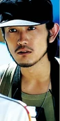 Tomitake portrayed by Masashi Taniguchi in the live action movies