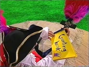 Captain Feathersword looking at a number book