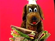 Puppet Wags having bacon and eggs sandwiches