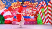 Santa (Franco Torrelli) doing a handstand in Santa's Rockin'!.