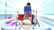 Anthony playing the Sonor drums (Note: The Wiggles logo in a Beatles type font)