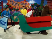 Captain and Wags riding in the cardboard sleigh