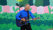 Anthony playing his blue Maton acoustic guitar in Nursery Rhymes