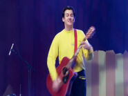 Sam playing Murray's red Maton acoustic guitar in "Wiggledancing! Live In Concert"