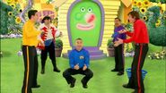 The Wiggles and Captain Feathersword playing tennis in front of Wigglehouse from "Get the Rhythm of the Hips"