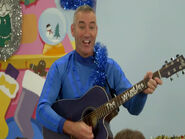 Anthony playing his blue Maton acoustic guitar in "Go Santa Go!"