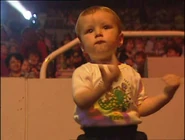 A little boy wearing The Wiggly Mascots shirt