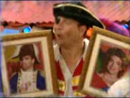 Captain Feathersword holding portraits of his parents