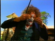 Wally wiping the cake frosting off his eyes