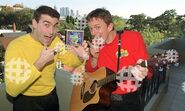 Greg holding CD and Murray holding yellow Takamine guitar