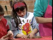 Sofia making a cat out of clay