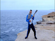 Anthony playing his blue Maton electric guitar on Clovelly Cliffs