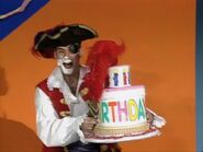 Captain Feathersword taking the birthday cake