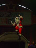 Santa (Nick Hutchinson) climbing a pole during the "Ready, Steady, Wiggle!" tour of 2013.
