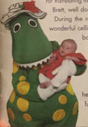 Dorothy the Dinosaur holding a baby. (As seen on the booklet for the Go To Sleep Jeff! CD.)