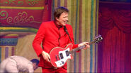 Murray holding red Maton guitar