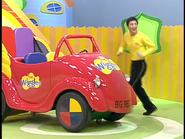 Carlos hiding behind the Big Red Car