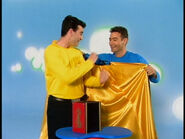 Anthony giving magic cape to Greg