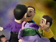 The puppeteer's head in the background