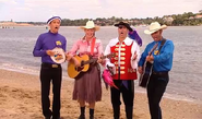 Anthony playing his blue Maton acoustic guitar in Splish Splash Big Red Boat