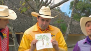 Greg holding up a drawing of the olive tree