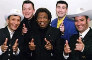 A picture of The Wiggles and Kamahl.