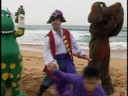 Captain Feathersword tickling Jeff at Manly Beach