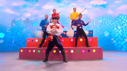 The Wiggles and Captain playing mop guitars