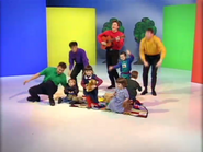 The Wiggles and the kids standing up