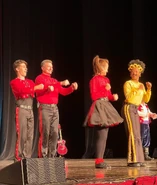 The full male outfit during a live concert in 2023.