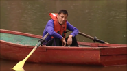 Jeff sleeping on a rowboat