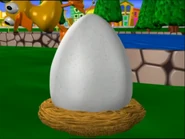 Duck falling off of the gigantic egg