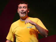 Greg singing on stage in 2004