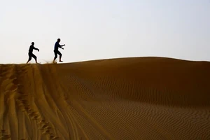 Jeff and Anthony in the sand of Abu Dhabi