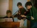 Anthony playing violin with John, along with Marie on piano